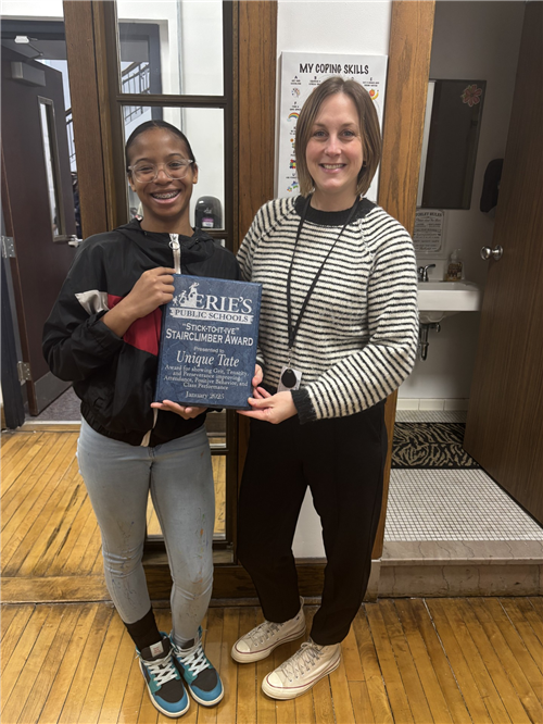 Unique Tate, Collegiate Academy's Stairclimber recipient for the month of January, poses with her plaque and school staff.